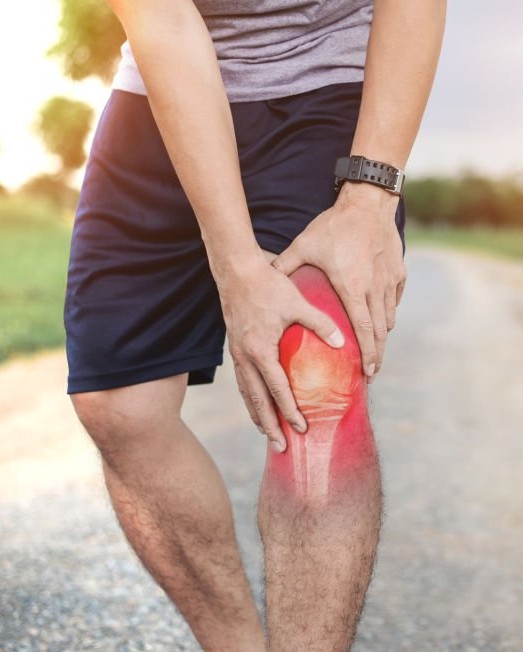 Man holding his knee in pain from osteoarthritis